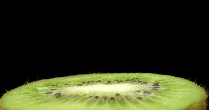 Fresh green kiwi fruit cut in half super macro close up shoot fly over laowa k4 high quallity