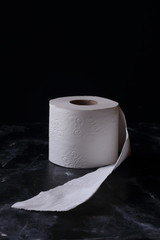 white toilet tissue ,paper on a  black background