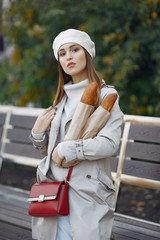 Girl with a baguette. Woman in a white beret. Lady in a french style.