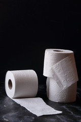 white toilet tissue ,paper on a  black background
