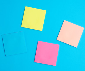 multicolored blank paper stickers of different colors on a blue background