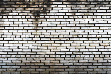 Background of an old, dirty, white brick wall with peeling plaster, painted walls, texture