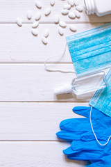 Medical protective antiviral concept. Protective blue medical mask, blue gloves, antiseptic spray