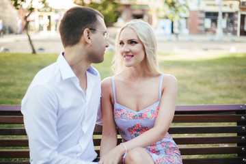 Obraz premium sitting on a bench in the city. couple in love