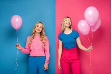 Cheerful blonde girls holding balloons on blue and pink background