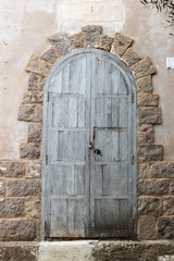 Fototapeta na wymiar beautiful vintage old wooden door in a stone wall of a church