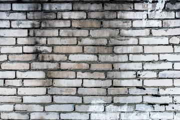 Obraz premium Background of an old, dirty, white brick wall with peeling plaster, painted walls, texture