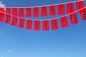 Morocco flag festive bunting hanging against a blue sky. 3D Render