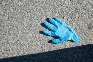 medical glove on the ground, covid19 protection 