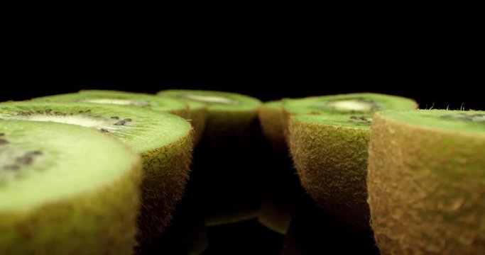 Juicy fresh green kiwi fruit cut in half super macro close up shoot fly over laowa k4 high quallity
