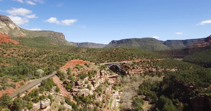 Aerial pullback from the Midgley Bridge to reveal Oak Creek flowing below, Sedona, Arizona.