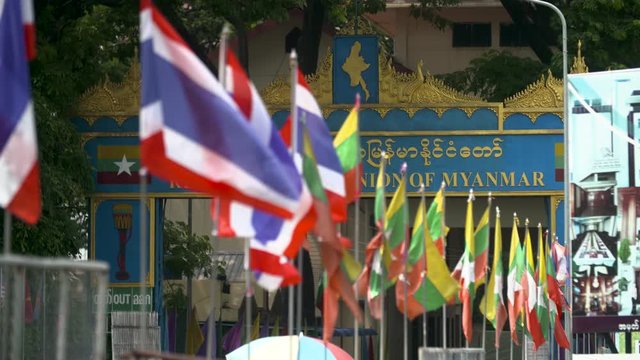 National Flag Of Myanmar And Thailand Swaying In The Wind In Front Of Tachileik Border In Mae Sai, Thailand. - close up shot