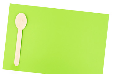 Eco friendly disposable cutlery utensils on green background. Bamboo wooden spoon. Zero waste concept