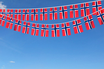 Norway flag festive bunting hanging against a blue sky. 3D Render