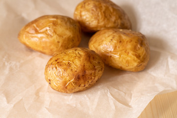 Young baked potatoes on baking paper