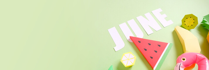 Exotic fruits made of paper on green background