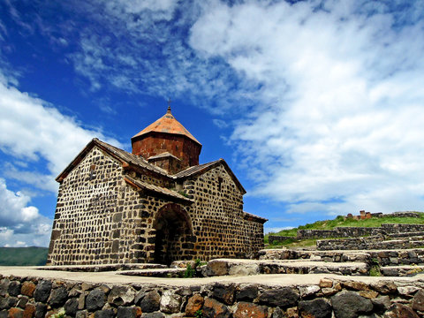 Armenian church Surp Arakelots on cloudy sky background. It was founded in 874 AD, built in very traditional style. Now it's one of most important & popular tourist attractions near Yerevan, Armenia