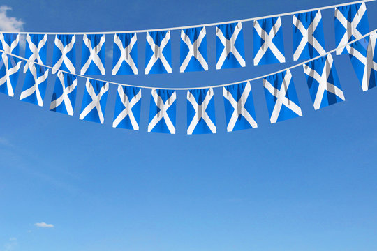 Scotland flag festive bunting hanging against a blue sky. 3D Render