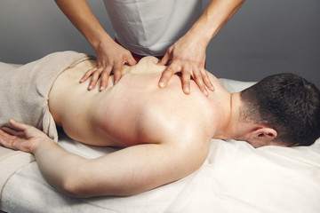 Fototapeta na wymiar Massage doctor. The man is undergoing rehabilitation