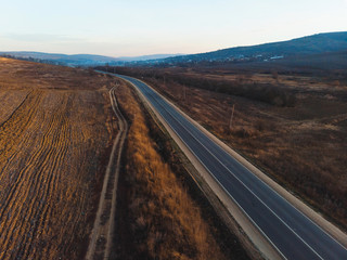Fototapeta premium empty road between fields