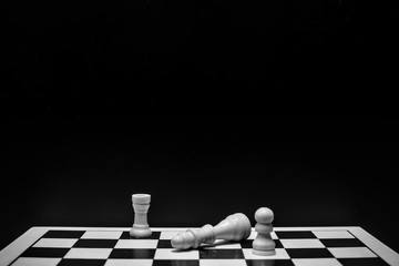 Chess pieces on the board with black background