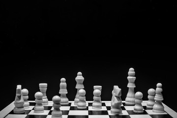 Chess pieces on the board with black background