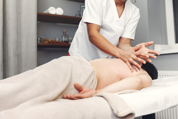 Obraz na płótnie Canvas Massage doctor. The man is undergoing rehabilitation
