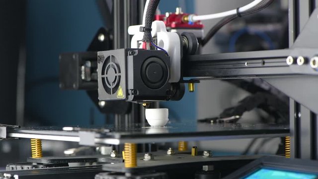4K The 3D printer prints white plastic model. modern technology.