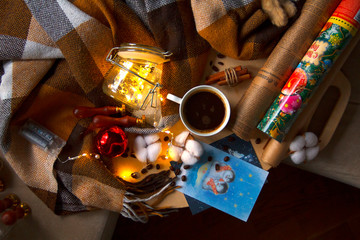 Wrapped in a plaid New Year's garland, coffee, paper and other stuff.