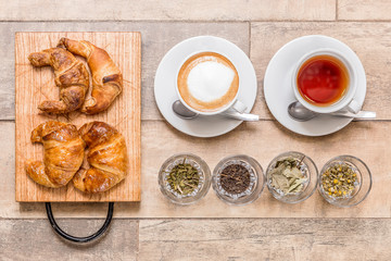 coffee and te great breakfast croissant on wooden table top view