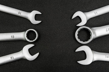 Group chrome plated wrench. Isolated on a black relief background.