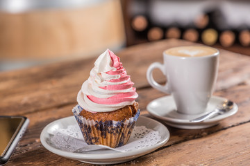 coffee with milk with cupcake note and  cell phone