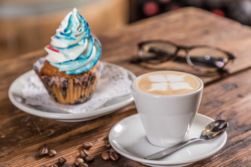 coffee with milk with cupcake note and  glasses 