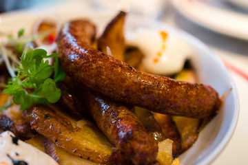 Nicely served tasty sausage with potato and egg.
