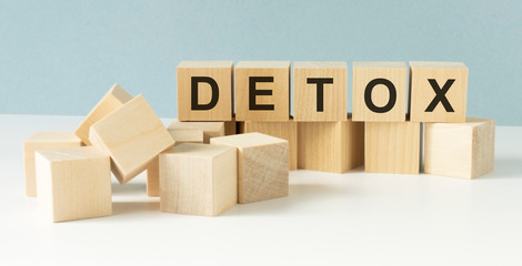 DETOX text on wooden cubes on wooden background