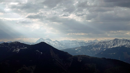 beautiful morning on the mountains with sunbeams and clouds and view to the alps