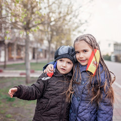 Kids wearing off the respirator medical mask in France and Spain flag colors, end of quarantine