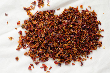 Dried pepper pile on linen background. Dried paprika.
