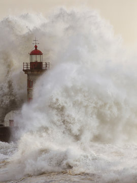 Stormy wave splash covering old lighthouse © Zacarias da Mata