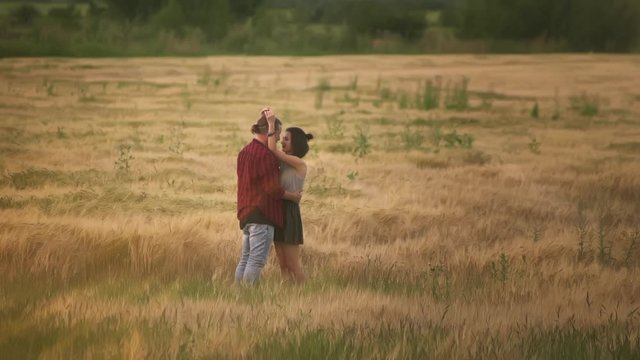 lovers man and woman travel in the field holding hands. Follow me, a young happy couple running along golden wheat field. happy family concept. beautiful girl hug her boyfriend. hand in hand
