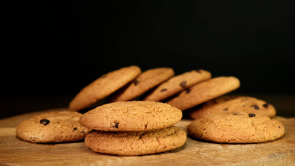Stack of Chocolate chip cookies on wooden background. Close up