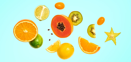 Fototapeta na wymiar Flying fruits healthy summer background. Papaya, orange, kiwi, melon. Levitation, falling fly fruit on blue. Tropical creative concept. Colorful fruity summertime vivid design