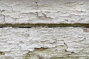 Vintage wooden plank with flaking white paint