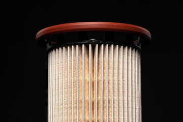 Car engine filter on dark background.