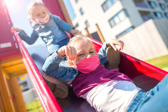 Chidren With A Face Mask On Playground