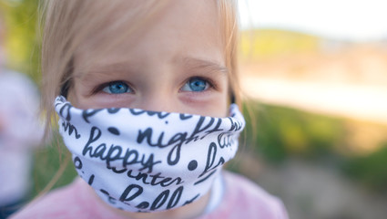 child with a face mask