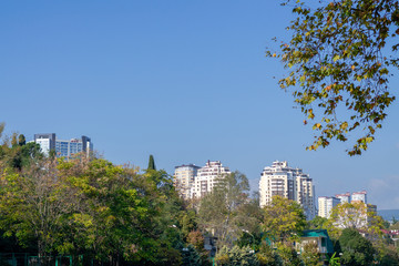 Fototapeta premium Tall apartment buildings. Off-season. Blue sky