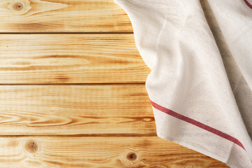 Kitchen towel or napkin over the wooden table. Close up.