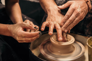 Hands of a potter at work close-up