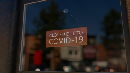 Close-up on a closed sign in the window of a shop displaying the message 